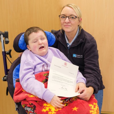 Anna Cahoon with her letter from Buckingham Palace and Support Worker Catherine Whiteford.