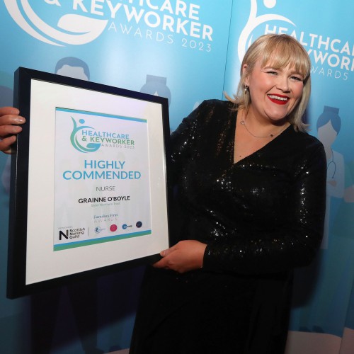 Grainne O’Boyle who was Highly Commended in the Nurse of the Year category. Grainne O'Boyle holding her framed certificate.